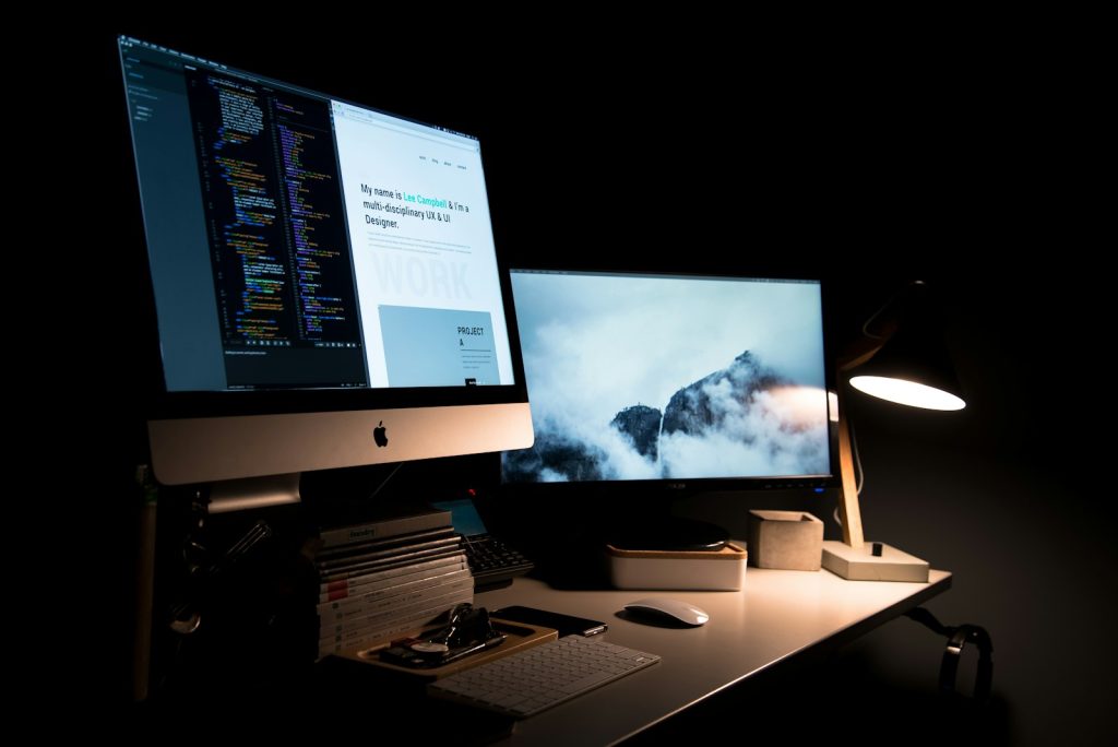Minimal desk with a large monitor showing a clean website layout