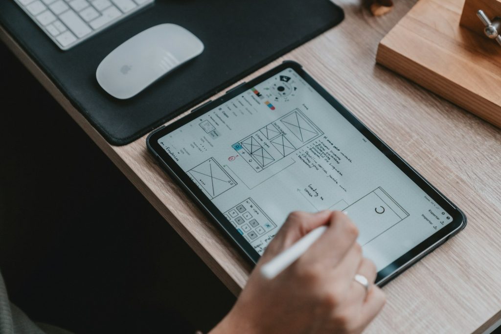 Designer sketching website wireframes on paper